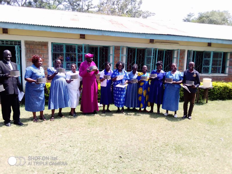 Amani CBO: Mother Union department with Bishop of Katakwa Diocese in a group photo during training women -Sun 24 solar project